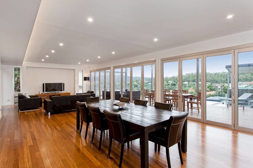 Large modern formal open concept living room in Brisbane with white walls and light hardwood floors.