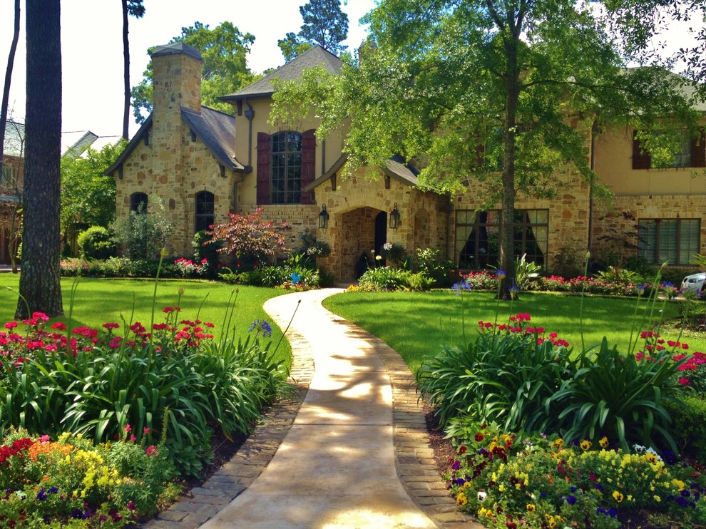 Inspiration for a large mediterranean front yard partial sun formal garden for spring in Houston with a garden path and brick pavers.