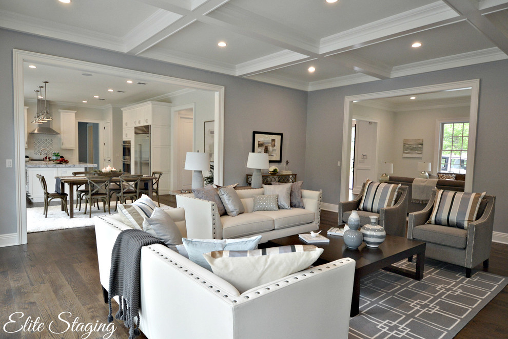 This is an example of a large transitional open concept family room in New York with grey walls and dark hardwood floors.