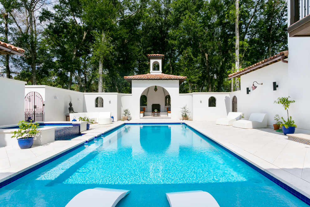 Large mediterranean courtyard rectangular pool in Charleston with concrete pavers and a pool house.