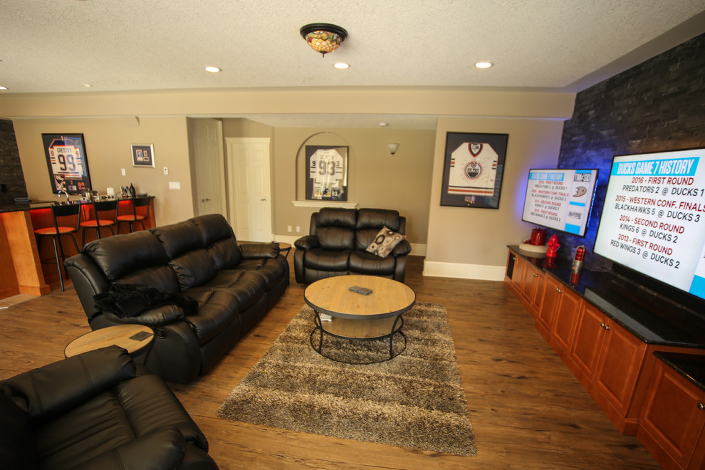 Design ideas for a large eclectic walk-out basement in Edmonton with beige walls, medium hardwood floors, no fireplace and brown floor.