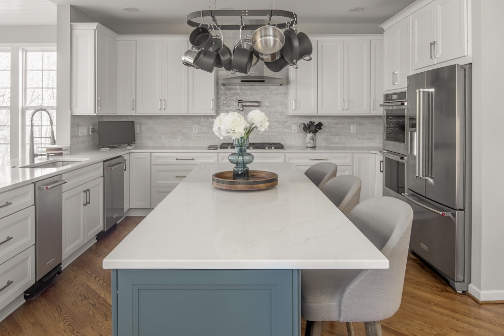 Inspiration for an expansive transitional u-shaped eat-in kitchen in Charlotte with an undermount sink, recessed-panel cabinets, quartz benchtops, stainless steel appliances, with island and white benchtop.