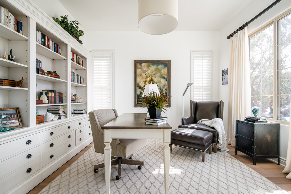 Large transitional study room in Los Angeles with white walls, light hardwood floors, a freestanding desk and beige floor.
