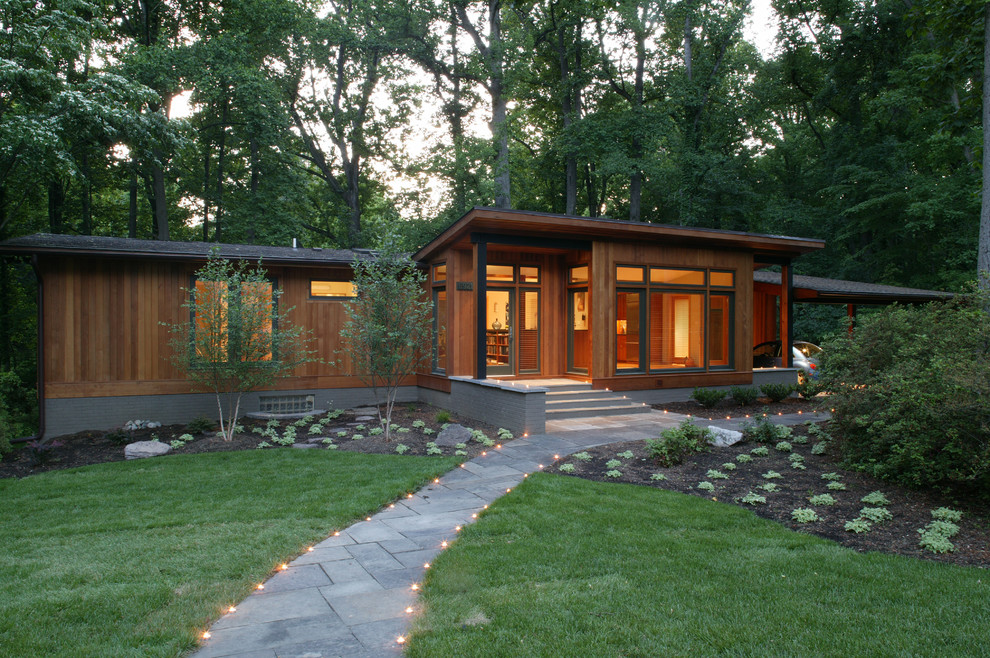 Photo of a midcentury one-storey brown exterior in DC Metro with wood siding and a hip roof.