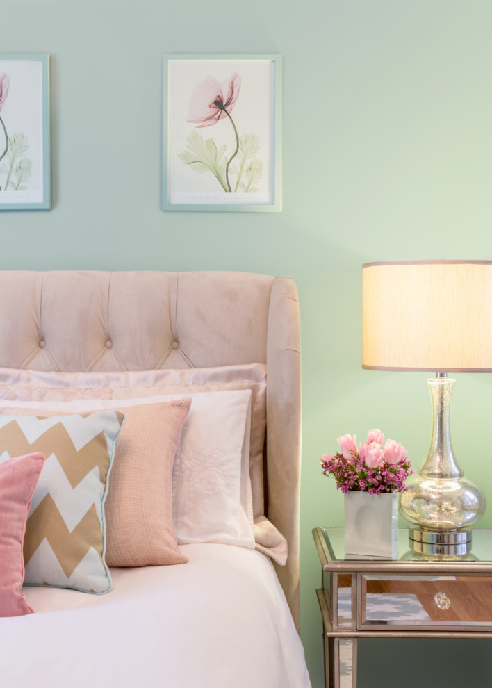Example of a transitional bedroom design with green walls