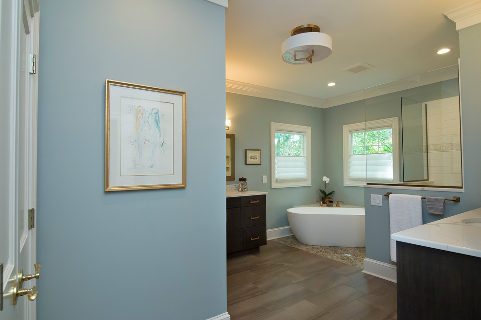 Photo of a large transitional master bathroom in Raleigh with flat-panel cabinets, dark wood cabinets, a freestanding tub, a curbless shower, a two-piece toilet, white tile, cement tile, blue walls, porcelain floors, an undermount sink, engineered quartz benchtops, multi-coloured floor, an open shower and white benchtops.
