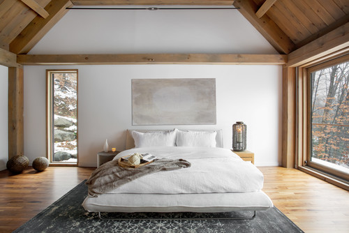 modern minimalist bedroom with low platform bed and large area rug underneath