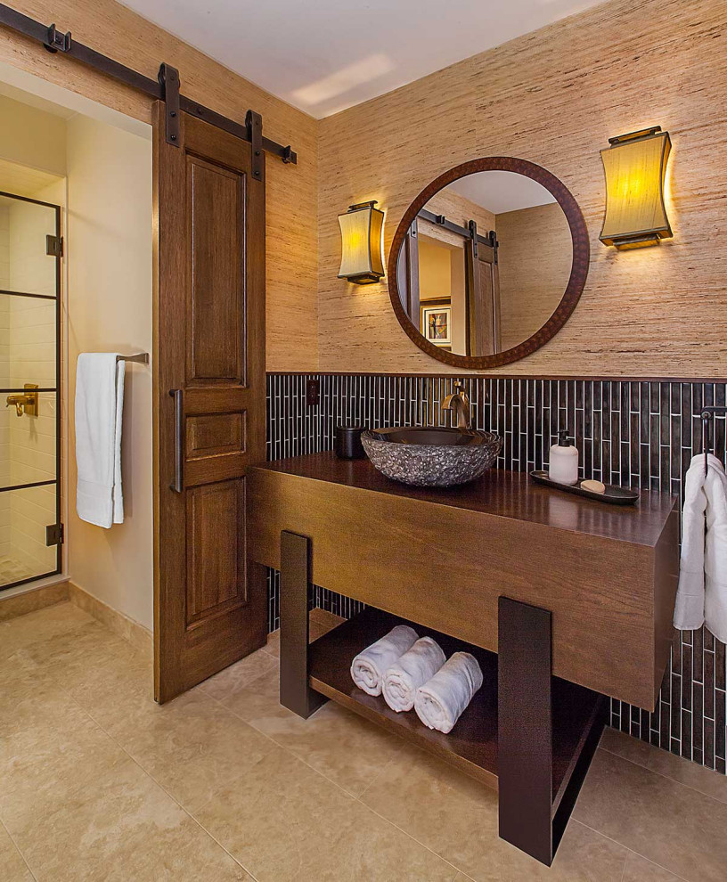 This is an example of a mid-sized contemporary 3/4 bathroom in Detroit with dark wood cabinets, an alcove shower, a two-piece toilet, brown tile, ceramic tile, beige walls, ceramic floors, a vessel sink, wood benchtops, beige floor, a hinged shower door, brown benchtops, a single vanity, a freestanding vanity, wallpaper and a niche.