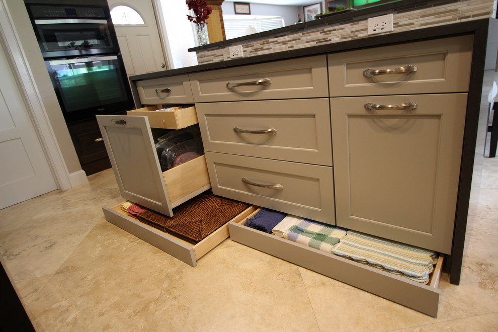 Example of a large transitional galley ceramic tile and beige floor open concept kitchen design in Miami with an undermount sink, flat-panel cabinets, gray cabinets, quartzite countertops, black appliances, beige backsplash, matchstick tile backsplash and an island