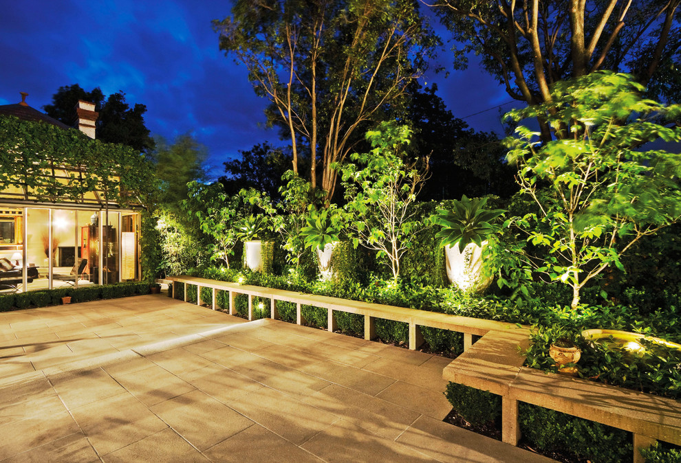 Inspiration for an eclectic courtyard shaded garden in Melbourne with natural stone pavers.