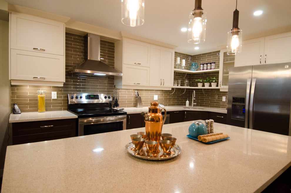 This is an example of a modern l-shaped kitchen in Ottawa with a single-bowl sink, white cabinets, granite benchtops, glass tile splashback, stainless steel appliances and with island.