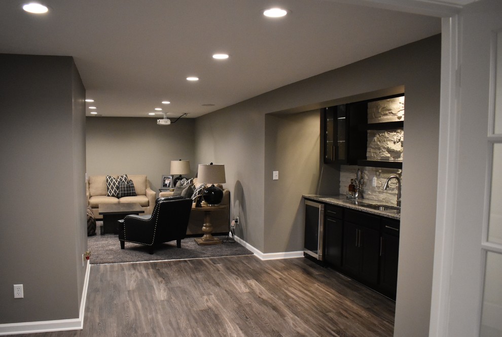 Design ideas for a mid-sized transitional look-out basement in Indianapolis with grey walls and carpet.