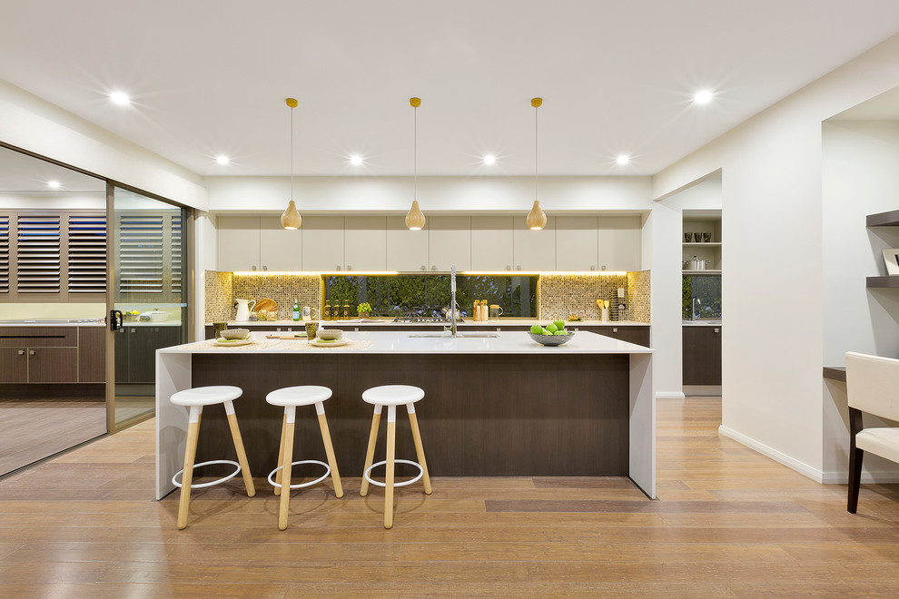 Photo of a large contemporary galley eat-in kitchen in Sydney with an undermount sink, dark wood cabinets, quartzite benchtops, beige splashback, mosaic tile splashback, with island and flat-panel cabinets.