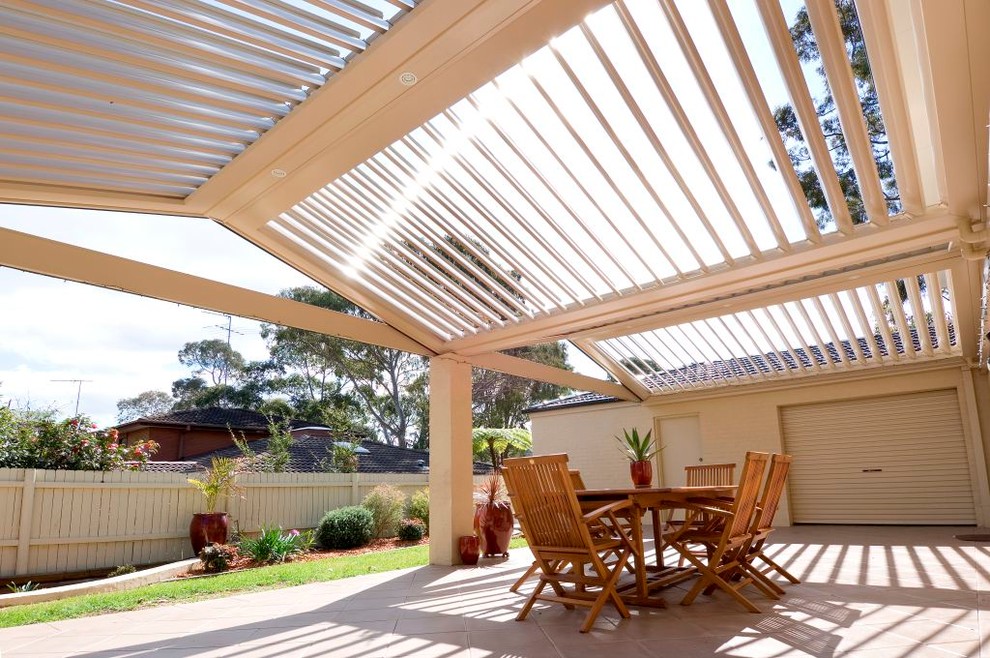 Contemporary courtyard patio in Sydney with tile and a pergola.