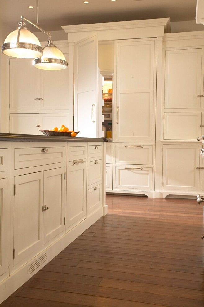 Transitional dark wood floor kitchen photo in Chicago with an undermount sink, shaker cabinets, white cabinets, marble countertops, white backsplash, paneled appliances and an island
