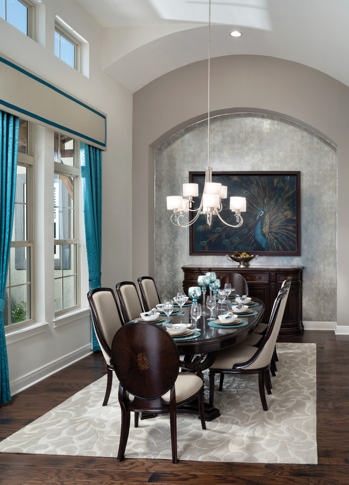 Large tropical separate dining room in Tampa with grey walls and medium hardwood floors.