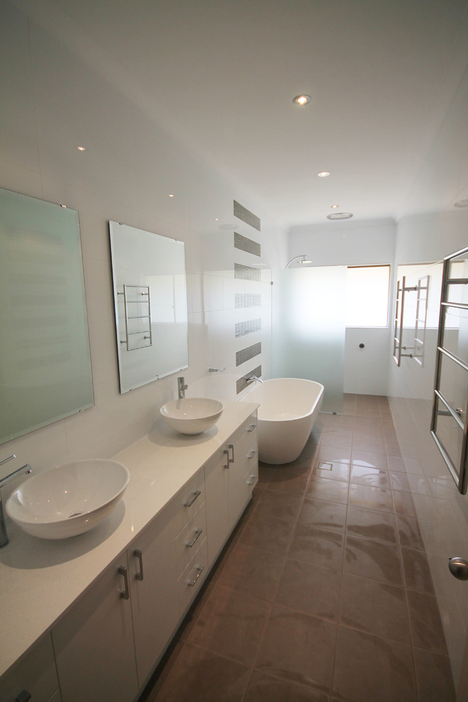 Contemporary bathroom in Perth with white cabinets, a freestanding tub, an open shower, brown tile and white walls.