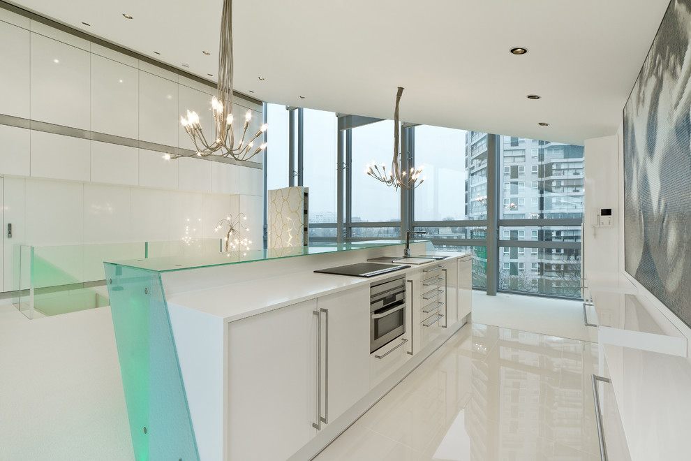 Design ideas for a contemporary kitchen in London with glass benchtops.