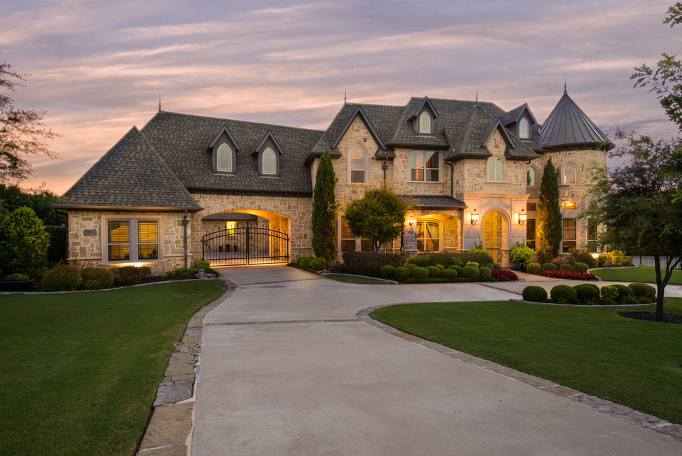Traditional beige three-story stone house exterior idea in Dallas with a hip roof and a shingle roof