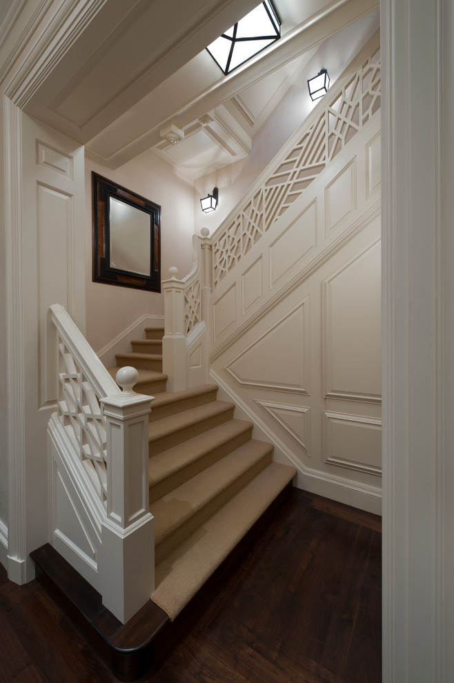 Mid-sized traditional carpeted u-shaped staircase in Miami with wood risers.