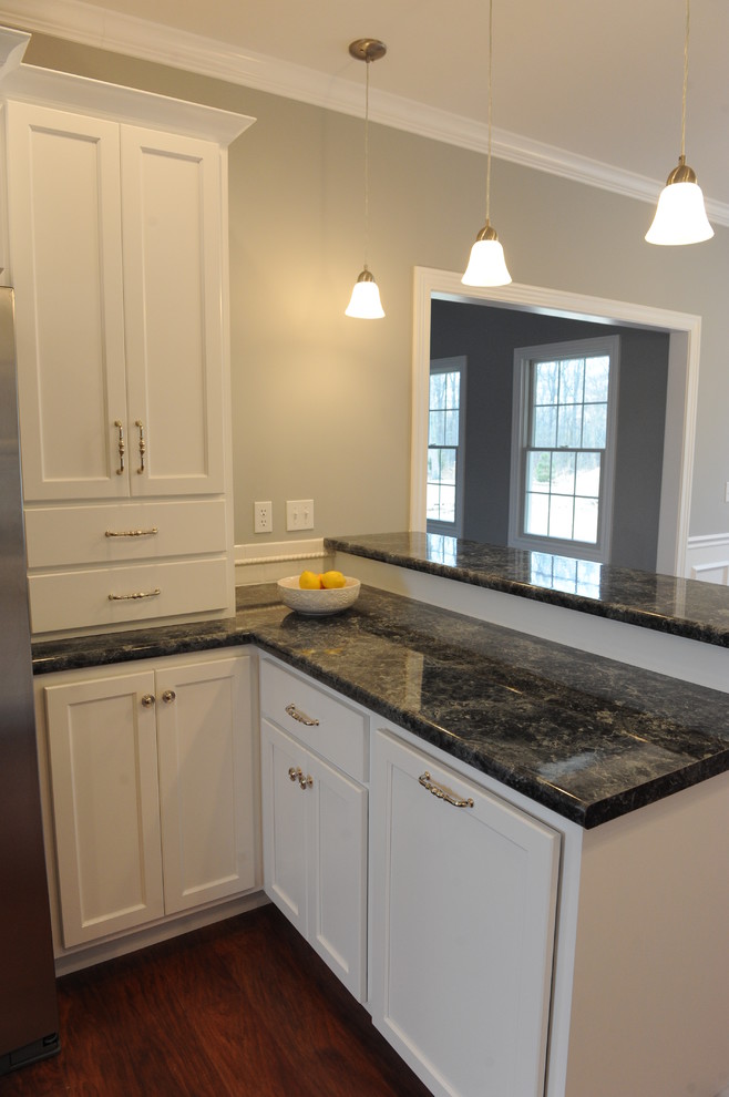 Eat-in kitchen - transitional u-shaped eat-in kitchen idea in Chicago with a drop-in sink, flat-panel cabinets, white cabinets, laminate countertops, white backsplash and subway tile backsplash