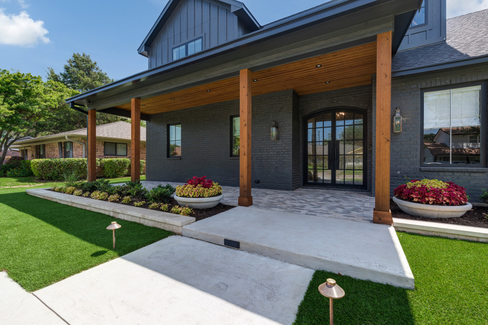 Inspiration for a large country front yard verandah in Dallas with with columns, tile and a roof extension.