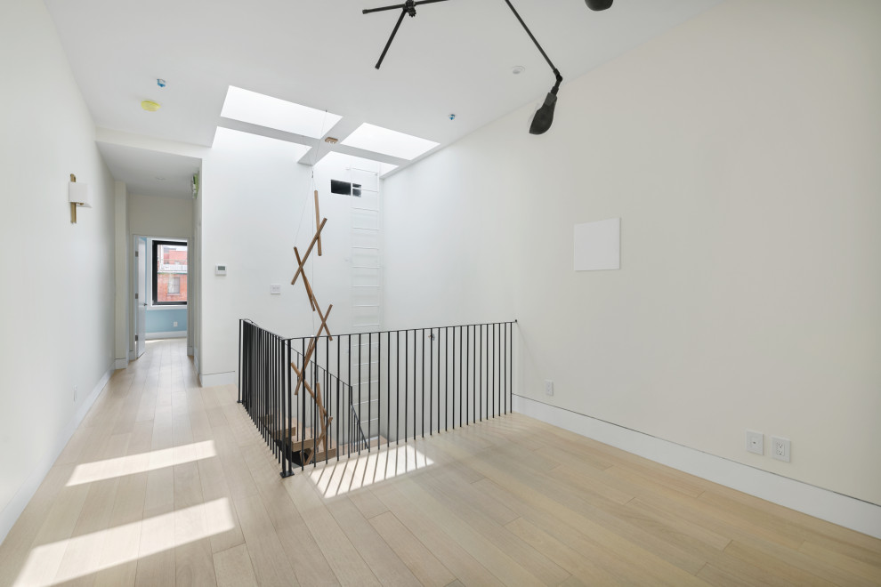 Großes Klassisches Wohnzimmer im Loft-Stil mit schwarzer Wandfarbe, hellem Holzboden und beigem Boden in New York