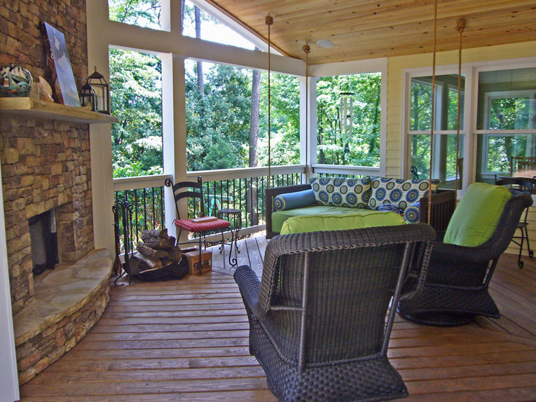 Photo of a mid-sized traditional backyard verandah in Atlanta with a roof extension.