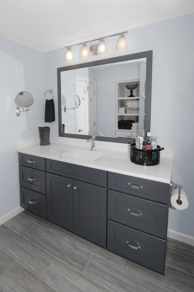 This is an example of a mid-sized transitional kids bathroom in Boston with shaker cabinets, grey cabinets, an alcove tub, a shower/bathtub combo, a two-piece toilet, blue walls, porcelain floors, an undermount sink, engineered quartz benchtops, grey floor and a shower curtain.