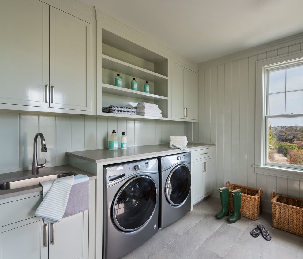Design ideas for a beach style single-wall dedicated laundry room in Providence with an undermount sink, open cabinets, a side-by-side washer and dryer, grey floor and grey benchtop.
