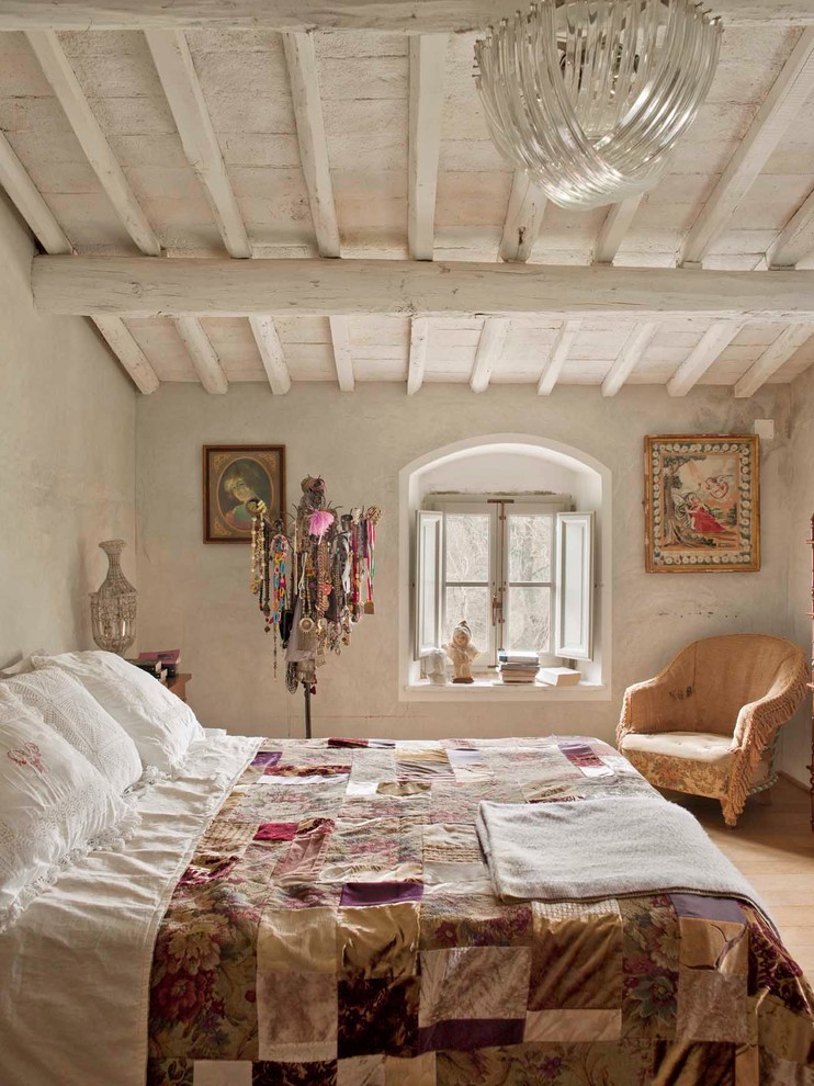 Inspiration for a mid-sized country master bedroom in Florence with medium hardwood floors.