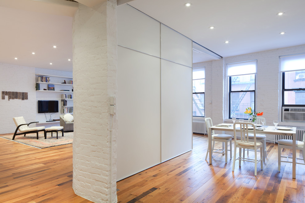 This is an example of a contemporary open plan dining in New York.
