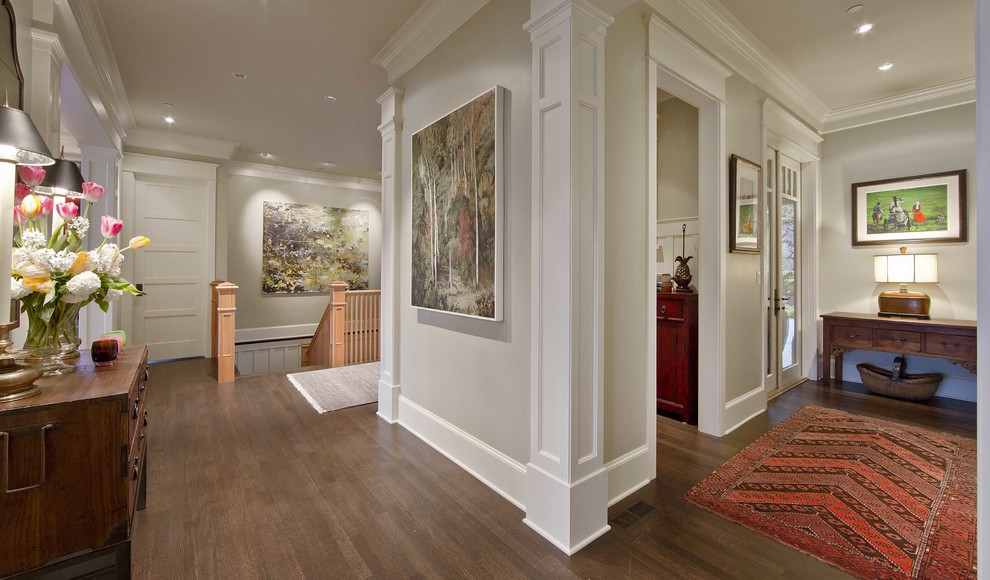 Design ideas for a large traditional hallway in Seattle with beige walls, dark hardwood floors and brown floor.