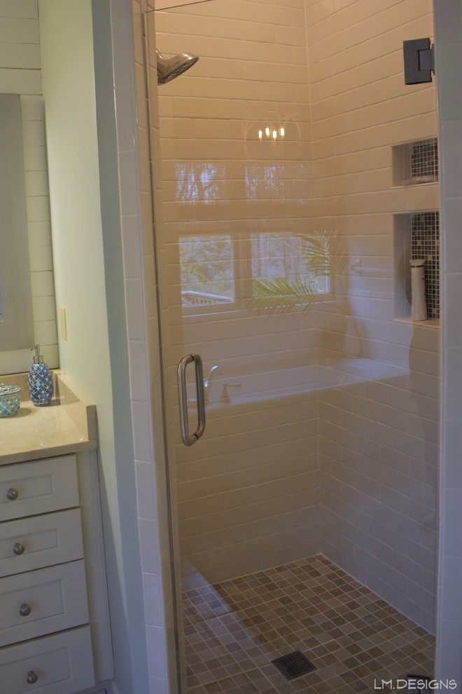 Example of a mid-sized transitional master white tile and subway tile ceramic tile and beige floor alcove bathtub design with recessed-panel cabinets, white cabinets, green walls, an undermount sink, marble countertops, a hinged shower door and beige countertops