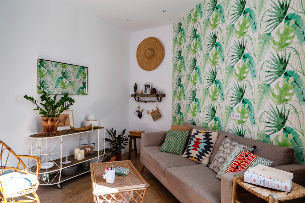 Eclectic living room in Madrid with multi-coloured walls, medium hardwood floors, brown floor and wallpaper.
