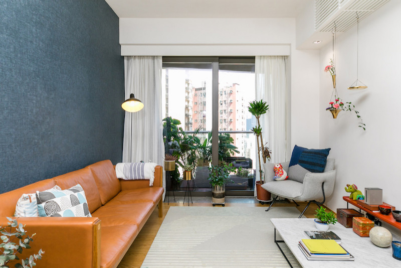 Design ideas for a small modern formal open plan living room in Hong Kong with multi-coloured walls, medium hardwood flooring, no fireplace, no tv and brown floors.