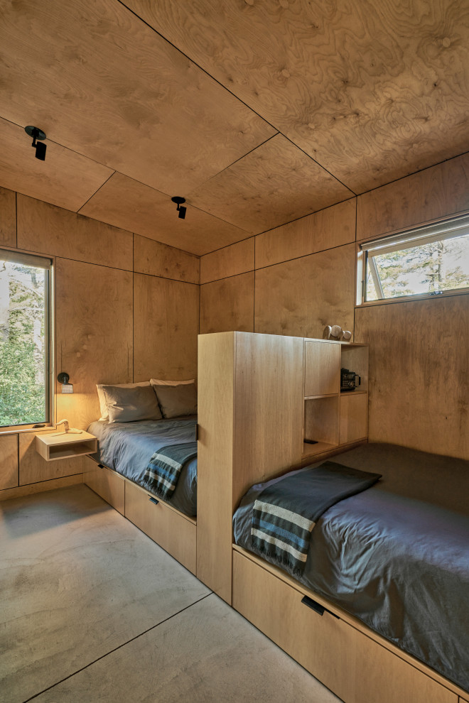 Photo of a rustic kids' bedroom in Seattle with concrete flooring, a wood ceiling and wood walls.