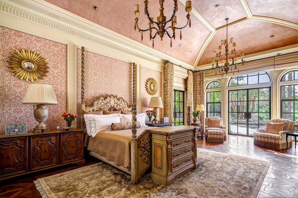 Inspiration for a large mediterranean master bedroom in Other with pink walls, medium hardwood floors, no fireplace and brown floor.