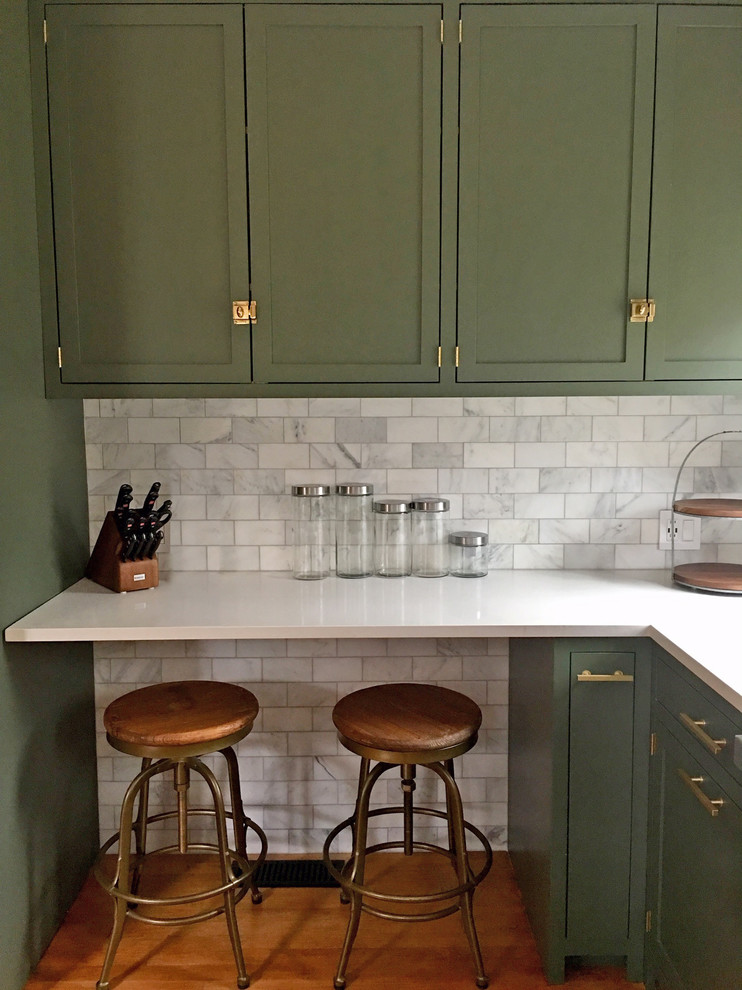 This is an example of a transitional kitchen in New York with shaker cabinets, green cabinets, quartz benchtops and marble splashback.