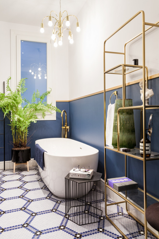 Mid-sized contemporary bathroom in Barcelona with mosaic tile floors, a freestanding tub, blue walls and multi-coloured floor.