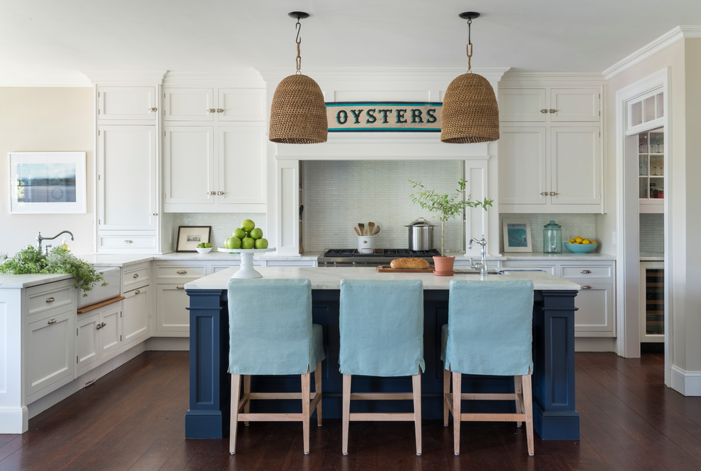 Inspiration for a beach style l-shaped kitchen in Providence with shaker cabinets, white cabinets, white splashback, stainless steel appliances, dark hardwood floors and with island.