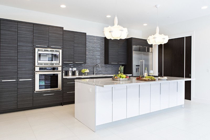 Design ideas for a large contemporary single-wall kitchen in Houston with an undermount sink, grey splashback, stone tile splashback, stainless steel appliances, porcelain floors, white floor, flat-panel cabinets, black cabinets, quartzite benchtops and with island.