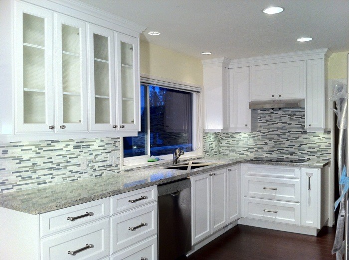 Inspiration for a mid-sized transitional galley dark wood floor enclosed kitchen remodel in Vancouver with a drop-in sink, recessed-panel cabinets, dark wood cabinets, marble countertops, multicolored backsplash, ceramic backsplash and stainless steel appliances