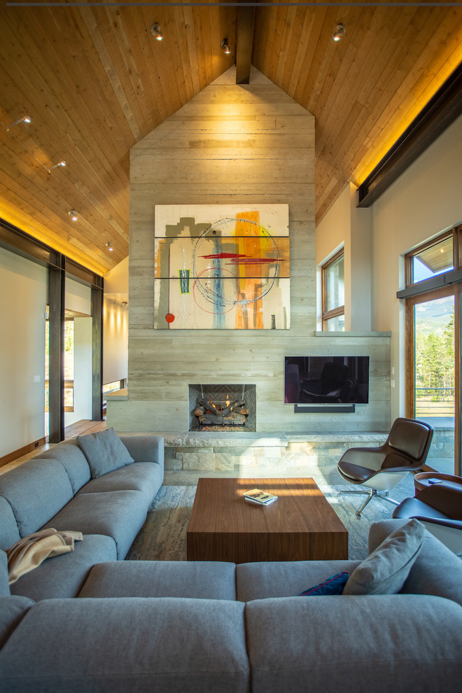 Country open concept living room in Denver with grey walls, a standard fireplace and a wall-mounted tv.
