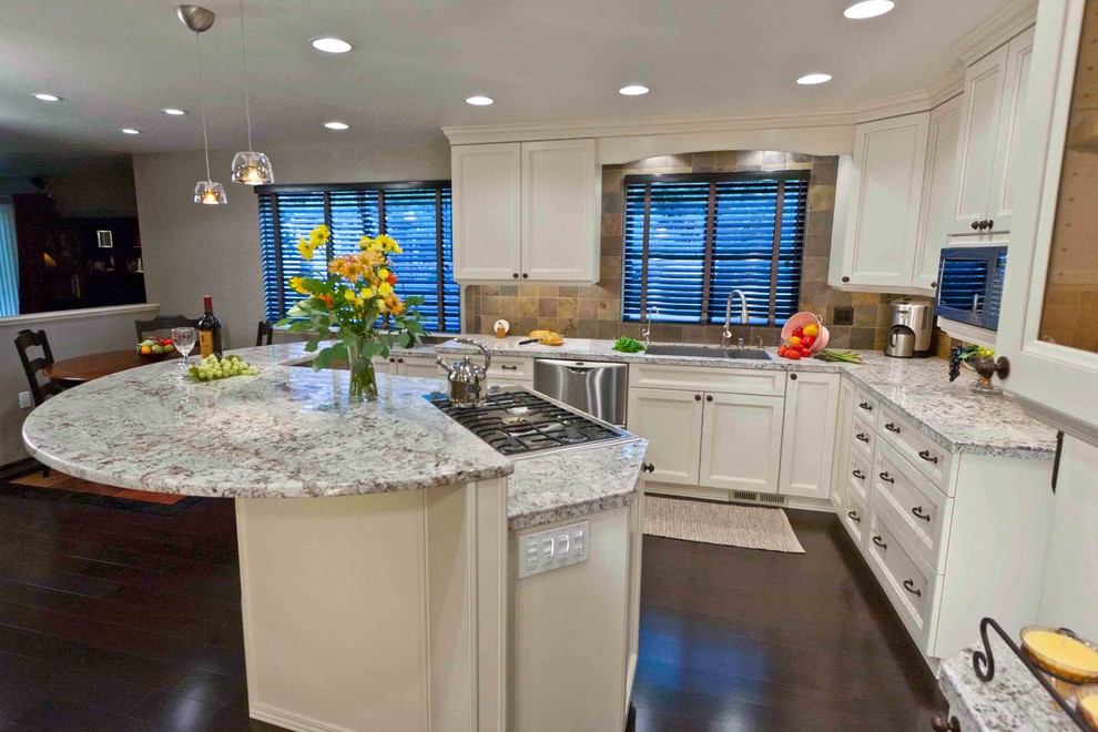 Eat-in kitchen - large transitional galley dark wood floor eat-in kitchen idea in Seattle with an undermount sink, white cabinets, granite countertops, stainless steel appliances and an island