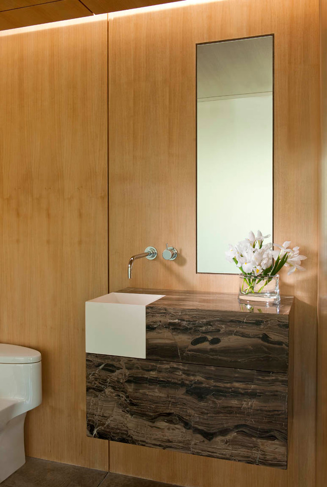 This is an example of a contemporary powder room in Dallas with a drop-in sink.