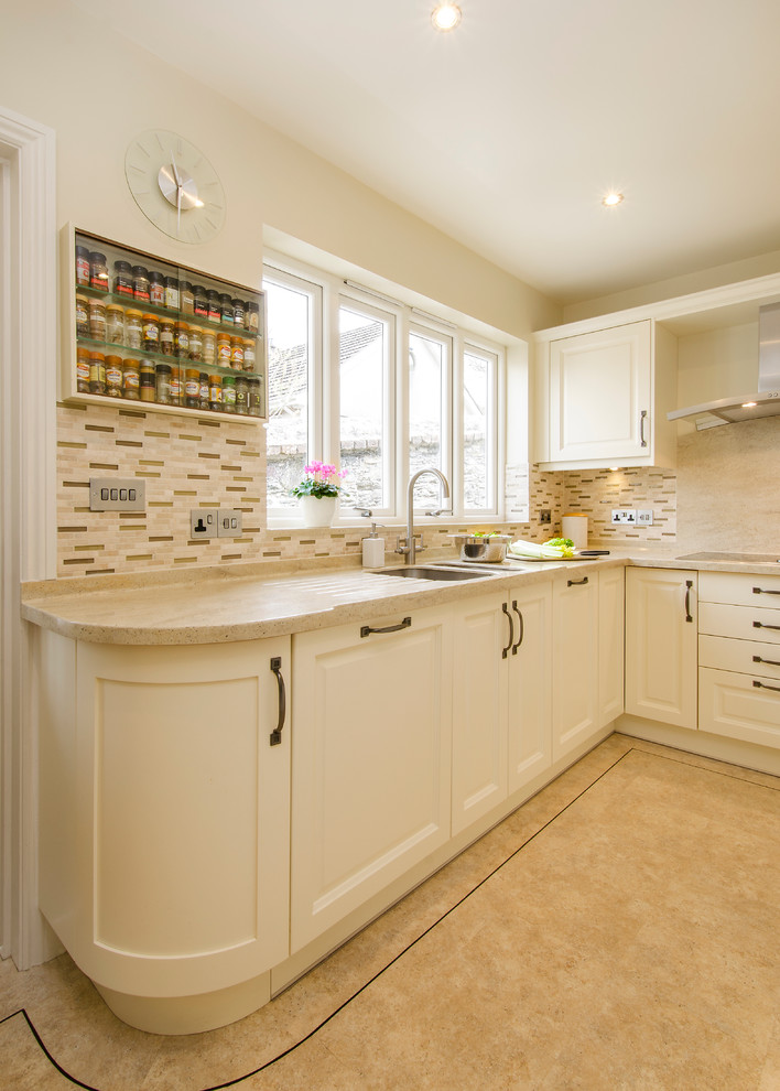 This is an example of a small traditional u-shaped enclosed kitchen in Cornwall with a double-bowl sink, beaded cabinets, quartz worktops, brown splashback, ceramic splashback, stainless steel appliances and no island.