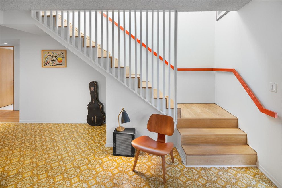 This is an example of a midcentury wood l-shaped staircase in Los Angeles with wood risers.