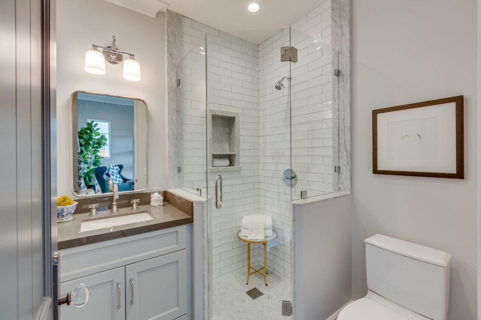 Inspiration for a small transitional 3/4 bathroom in Los Angeles with recessed-panel cabinets, white cabinets, an alcove shower, white tile, white walls, an undermount sink, a hinged shower door and brown benchtops.