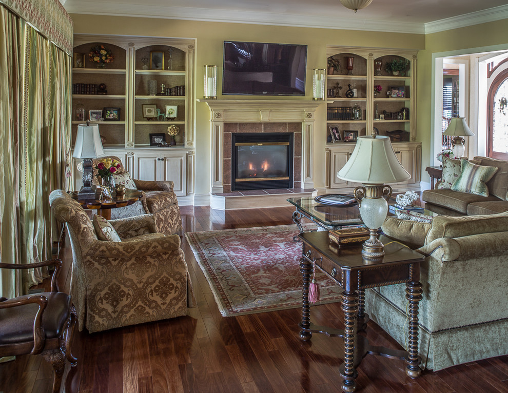 Photo of a large traditional open concept living room in DC Metro with medium hardwood floors and a standard fireplace.
